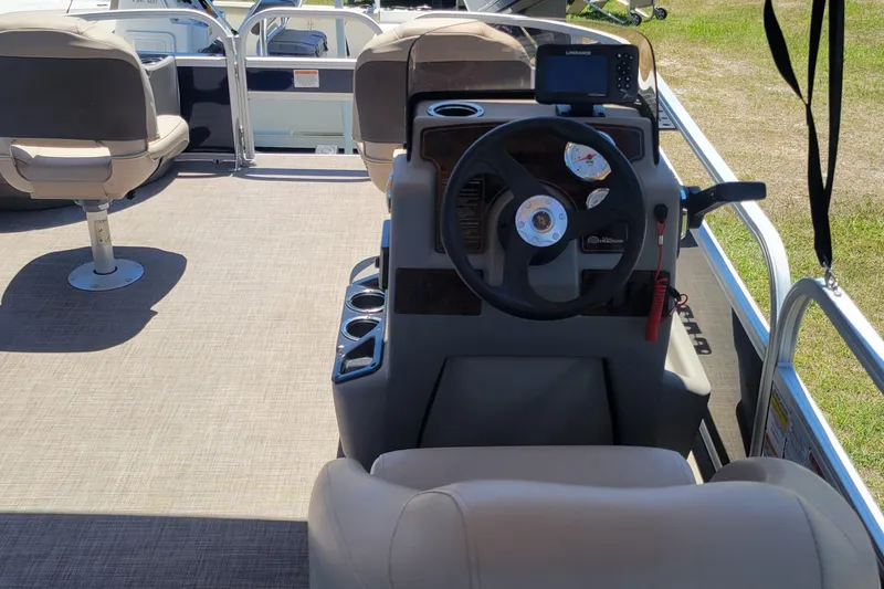 Slide: The Image of 2023 Sun Tracker Bass Buggy 18 DLX pontoon boat interior with steering console and seating. - 10
