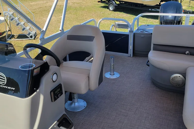 Slide: The Image of 2023 Sun Tracker Bass Buggy 18 DLX pontoon boat interior with seating and steering console. - 11