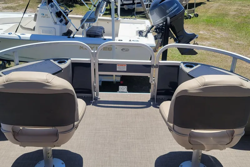 Slide: The Image of 2023 Sun Tracker Bass Buggy 18 DLX pontoon boat interior with seating and cup holders. - 12
