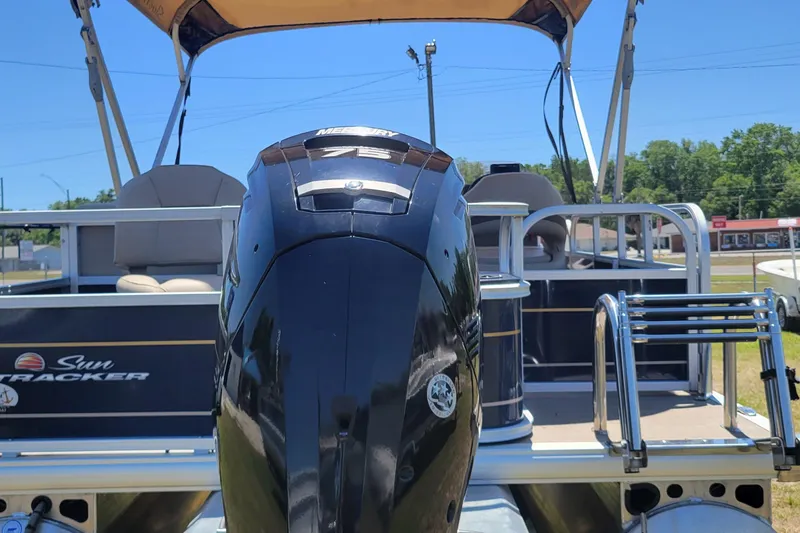 Slide: The Image of 2023 Sun Tracker Bass Buggy 18 DLX pontoon boat with Mercury engine, outdoor setting. - 3