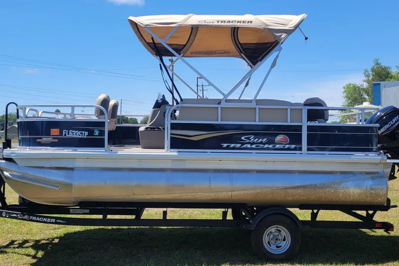 Slide: The Image of 2023 Sun Tracker Bass Buggy 18 DLX pontoon boat with canopy on trailer. - 5