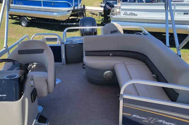 Slide: The Image of 2023 Sun Tracker Bass Buggy 18 DLX pontoon boat interior with seating and steering console. - 7