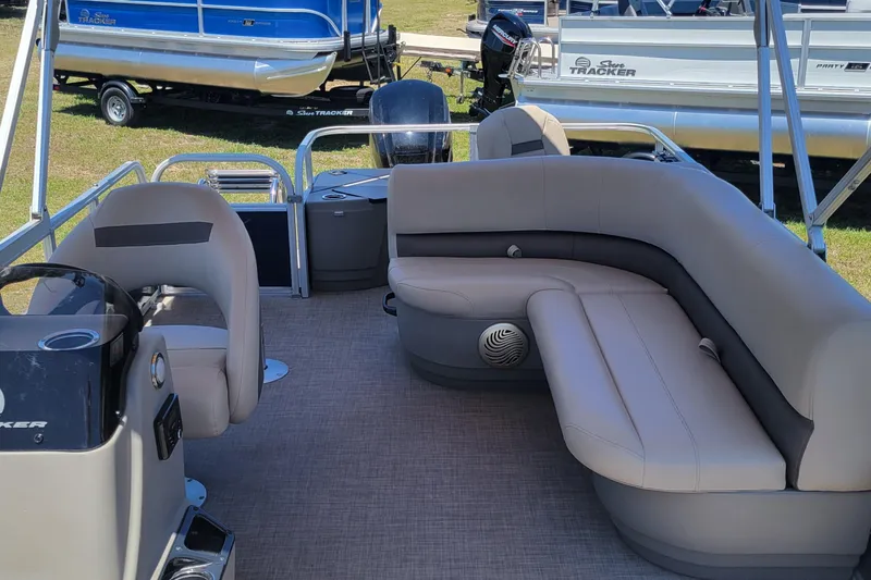 Slide: The Image of 2023 Sun Tracker Bass Buggy 18 DLX pontoon boat interior with seating and steering console. - 8
