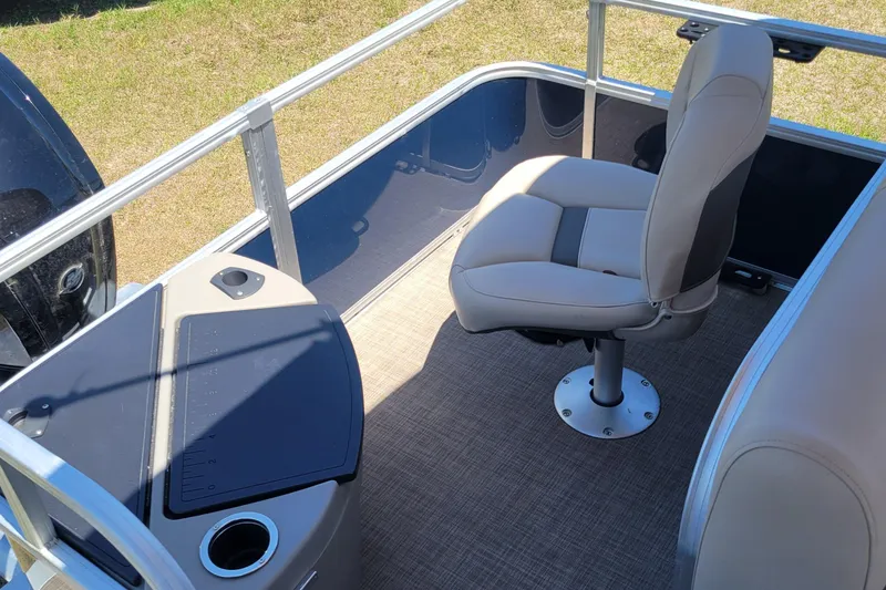 Slide: The Image of 2023 Sun Tracker Bass Buggy 18 DLX interior with beige seating and console. - 9