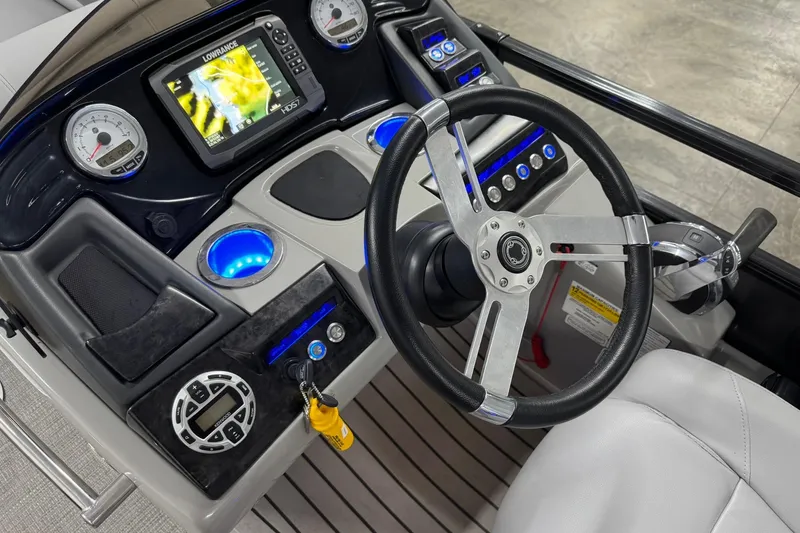 Slide: The Image of 2017 Regency 254 LE3 boat dashboard with steering wheel and navigation system. - 11