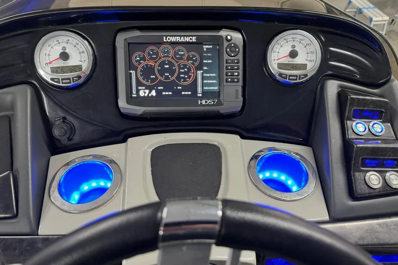 Slide: The Image of Dashboard of a 2017 Regency 254 LE3 boat with Lowrance HDS7 display and illuminated cup holders. - 13
