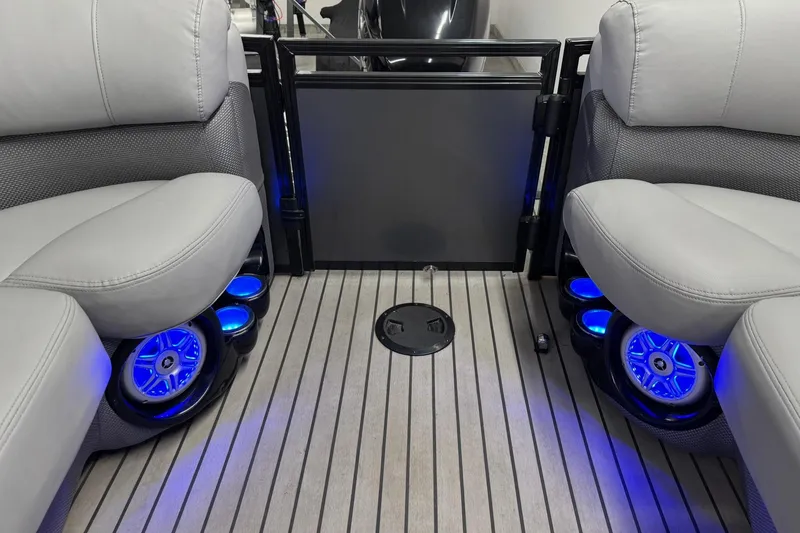 Slide: The Image of Luxurious 2017 Regency 254 LE3 boat interior with blue LED-lit speakers and plush seating. - 21