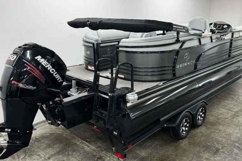 Slide: The Image of 2017 Regency 254 LE3 pontoon boat with Mercury engine on trailer, indoor display. - 4