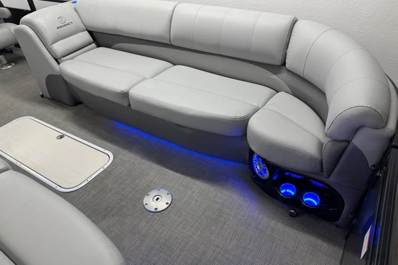 Slide: The Image of Luxurious 2017 Regency 254 LE3 boat interior with plush seating and ambient blue lighting. - 8