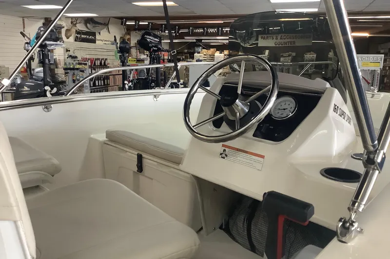 Slide: The Image of 2019 Boston Whaler 160 Super Sport interior with steering wheel and seating. - 3