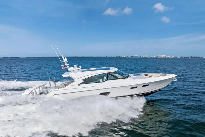 Slide: The Image of 2025 Formula 500 Super Sport Crossover cruising on open water under clear blue skies. - 1