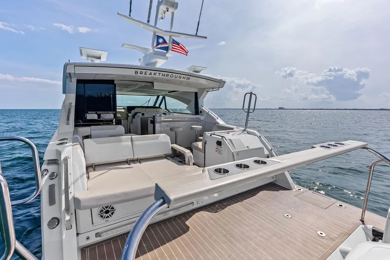 Slide: The Image of 2025 Formula 500 Super Sport Crossover yacht on open water, featuring luxurious seating and sleek design. - 12