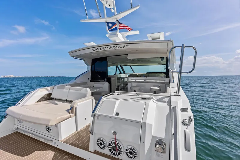 Slide: The Image of 2025 Formula 500 Super Sport Crossover yacht on open water, featuring luxurious seating and sleek design. - 14