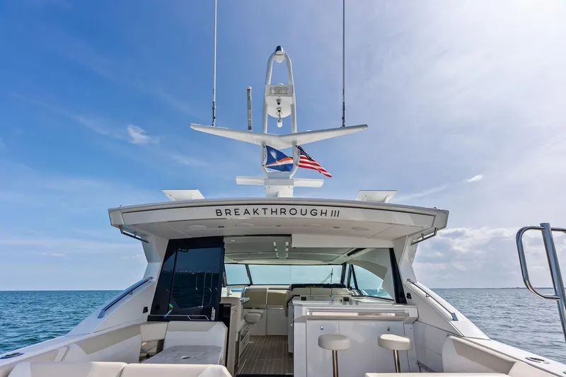 Slide: The Image of 2025 Formula 500 Super Sport Crossover yacht on open sea, featuring luxurious seating and sleek design. - 16