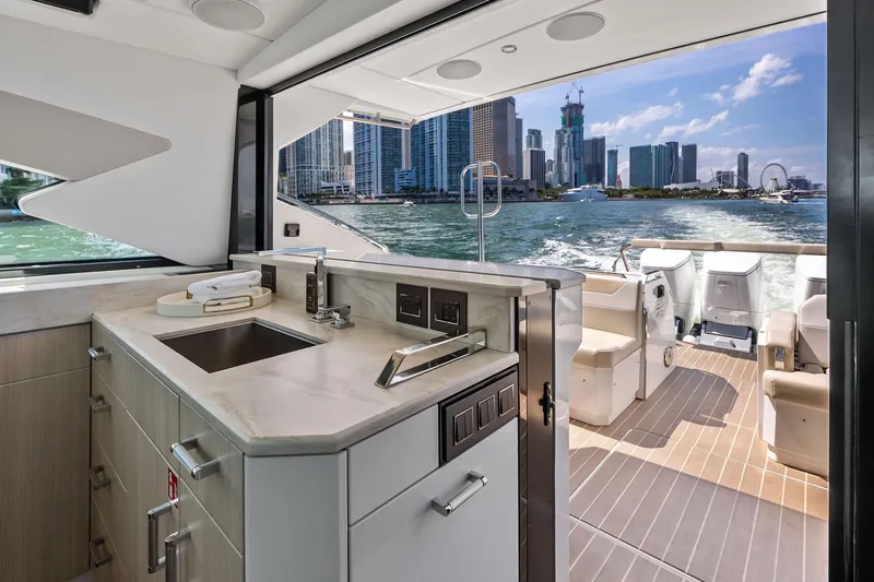Slide: The Image of Luxurious 2025 Formula 500 Super Sport Crossover yacht interior with city skyline view. - 18