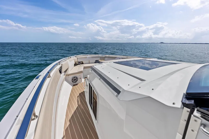Slide: The Image of 2025 Formula 500 Super Sport Crossover boat cruising on open sea under clear skies. - 21
