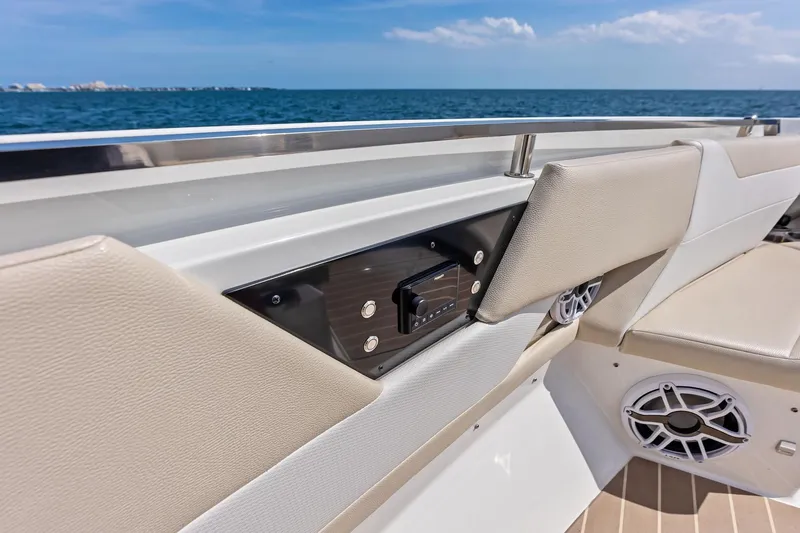 Slide: The Image of 2025 Formula 500 Super Sport Crossover boat interior with beige seating and audio system. - 30