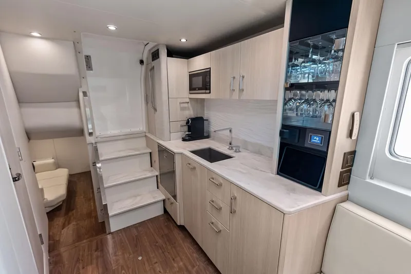 Slide: The Image of Luxurious interior of 2025 Formula 500 Super Sport Crossover with modern kitchen amenities. - 33