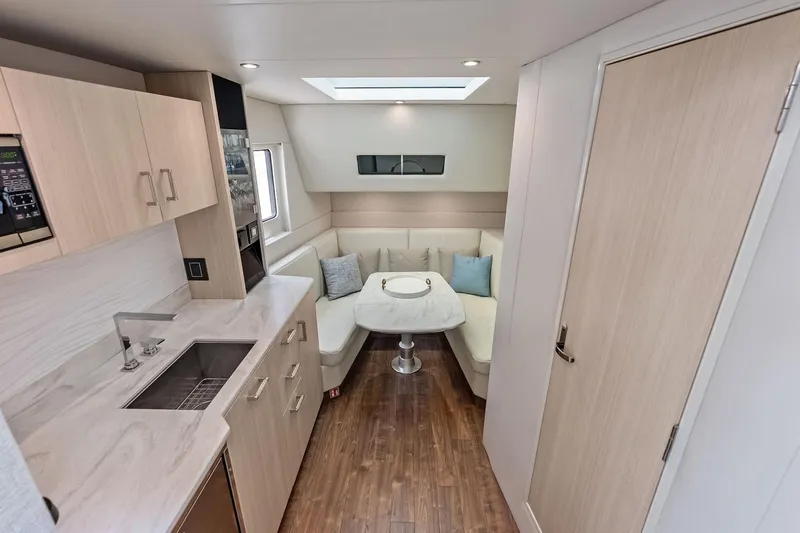 Slide: The Image of Luxurious interior of 2025 Formula 500 Super Sport Crossover with modern kitchen and seating area. - 36