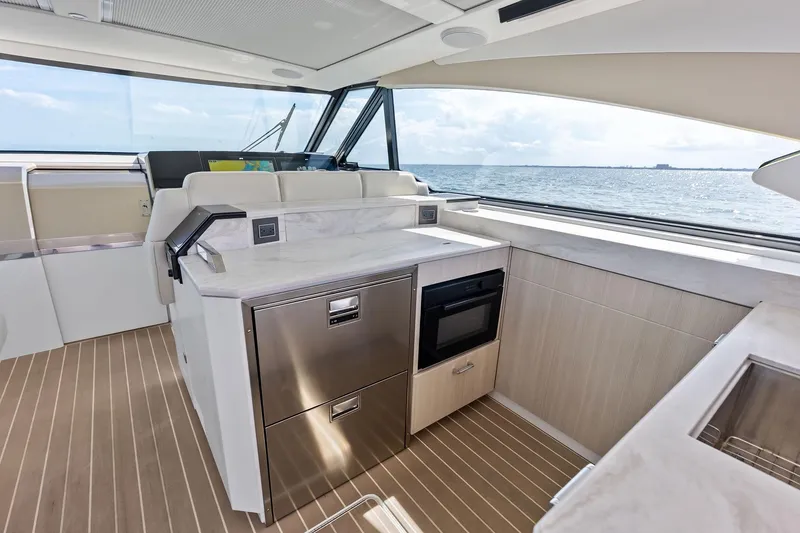 Slide: The Image of Luxurious interior of 2025 Formula 500 Super Sport Crossover yacht with modern kitchen amenities. - 37