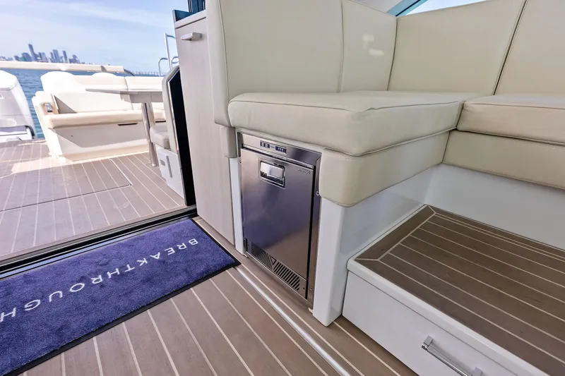 Slide: The Image of 2025 Formula 500 Super Sport Crossover interior with seating and mini fridge, overlooking city skyline. - 40
