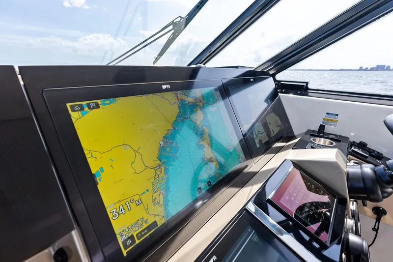 Slide: The Image of 2025 Formula 500 Super Sport Crossover dashboard with navigation display on open water. - 52