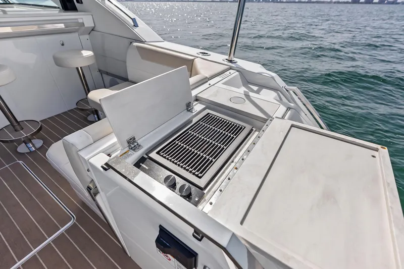Slide: The Image of Outdoor grill on 2025 Formula 500 Super Sport Crossover yacht deck, overlooking the ocean. - 56