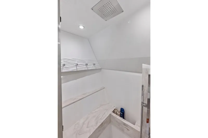 Slide: The Image of Luxurious interior of 2025 Formula 500 Super Sport Crossover boat, featuring sleek white shower design. - 60