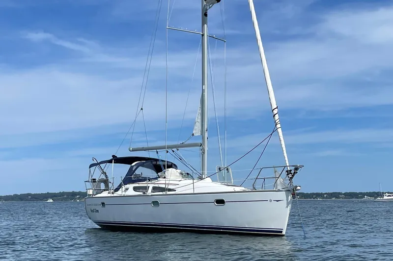 The Image of 2003 Jeanneau Sun Odyssey 35 sailboat on calm water under blue sky. - 0