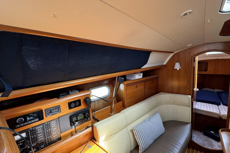 Slide: The Image of Interior of 2003 Jeanneau Sun Odyssey 35 yacht with cozy seating and wooden cabinetry. - 5