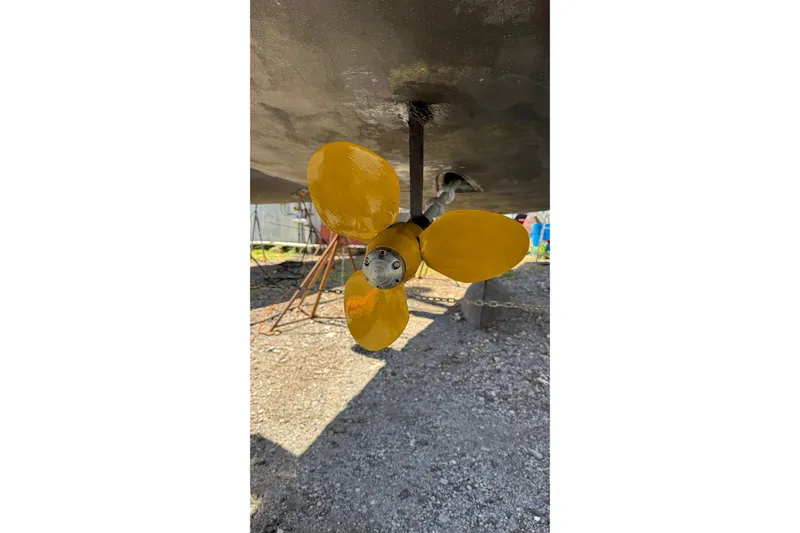 Slide: The Image of Yellow propeller of 2003 Jeanneau Sun Odyssey 35 sailboat on dry dock. - 6