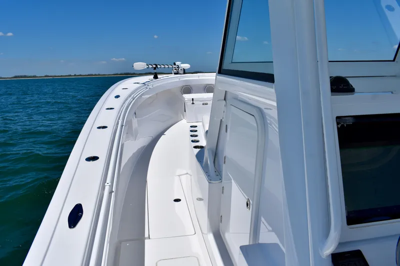 Slide: The Image of 2022 Onslow Bay 41 Tournament boat on open water, showcasing sleek design and spacious deck. - 10