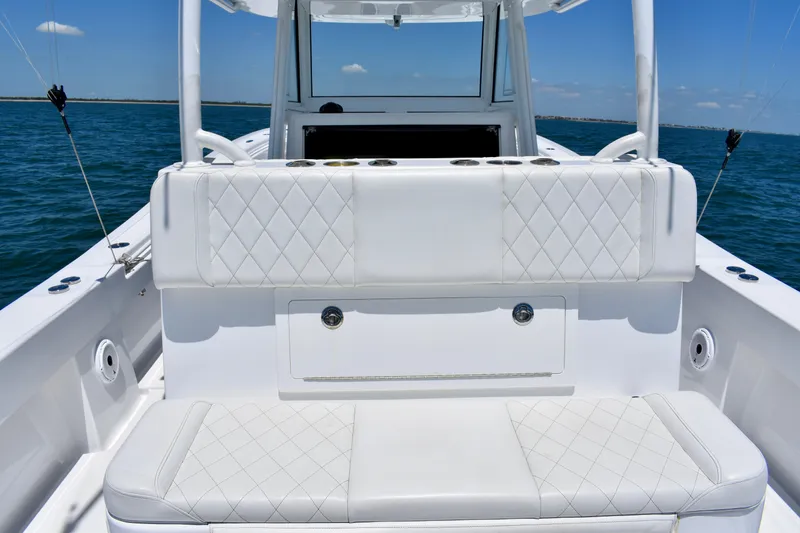Slide: The Image of 2022 Onslow Bay 41 Tournament boat interior with white cushioned seating on open water. - 12