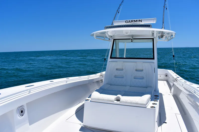 Slide: The Image of 2022 Onslow Bay 41 Tournament boat on open sea, featuring sleek white design and Garmin equipment. - 13
