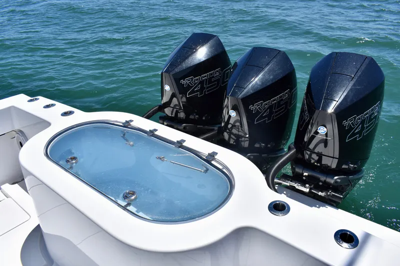 Slide: The Image of 2022 Onslow Bay 41 Tournament boat with triple Racing 450 engines on the water. - 16