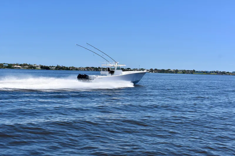 Slide: The Image of 2022 Onslow Bay 41 Tournament boat speeding on open water under clear blue sky. - 17