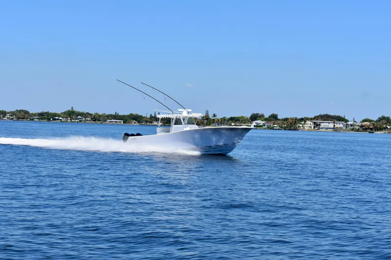 Slide: The Image of 2022 Onslow Bay 41 Tournament boat speeding on open water under clear blue sky. - 19