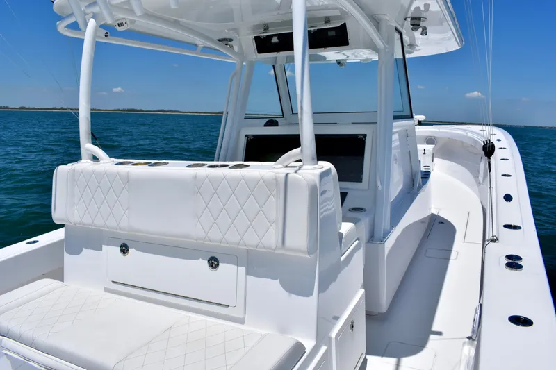 Slide: The Image of 2022 Onslow Bay 41 Tournament boat interior with white seating on open water. - 2