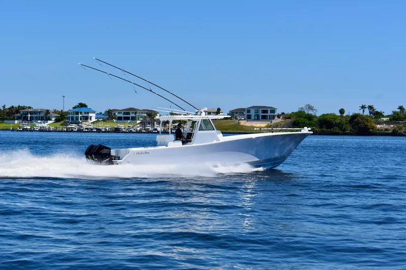 Slide: The Image of 2022 Onslow Bay 41 Tournament boat cruising on a sunny day near waterfront homes. - 23