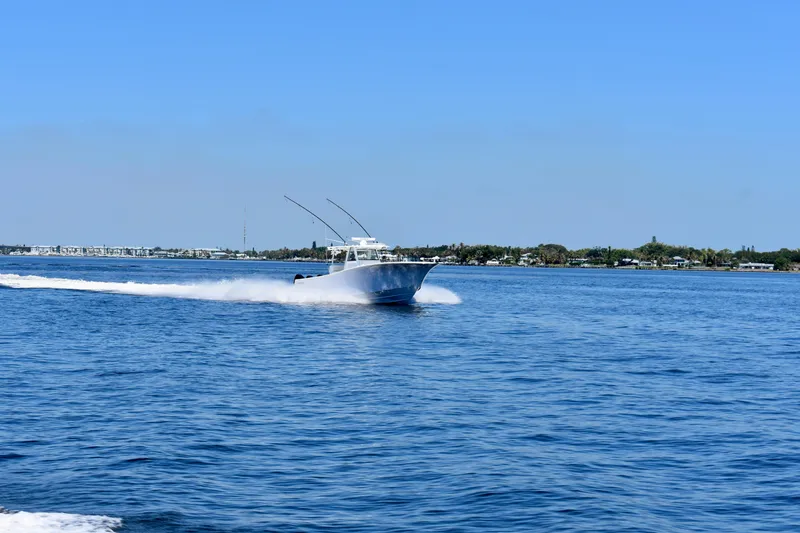 Slide: The Image of 2022 Onslow Bay 41 Tournament boat cruising on open water under clear blue sky. - 26