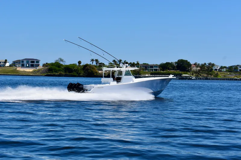 Slide: The Image of 2022 Onslow Bay 41 Tournament boat cruising on a sunny day near waterfront homes. - 28