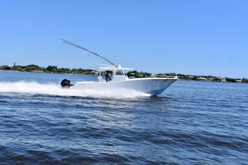 Slide: The Image of 2022 Onslow Bay 41 Tournament boat cruising on open water under clear blue sky. - 29