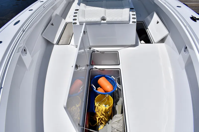 Slide: The Image of 2022 Onslow Bay 41 Tournament boat with open storage compartments and fishing gear. - 34