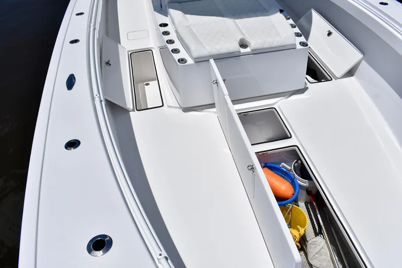 Slide: The Image of 2022 Onslow Bay 41 Tournament boat deck with open storage compartments. - 35