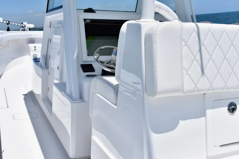 Slide: The Image of 2022 Onslow Bay 41 Tournament boat interior with white seating and steering wheel. - 5