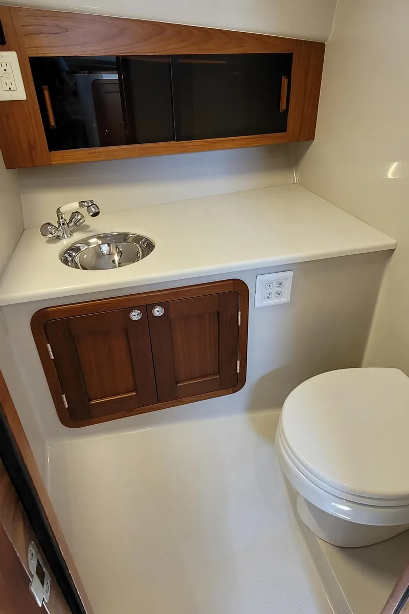 Slide: The Image of Interior of 2015 Eastport 32 OBX with sink and toilet. - 16