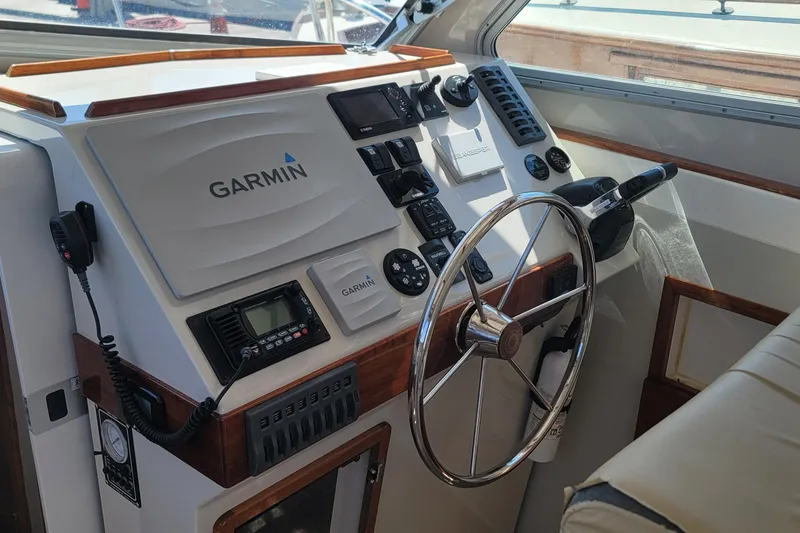 Slide: The Image of Helm of 2015 Eastport 32 OBX boat with Garmin navigation system and steering wheel. - 18