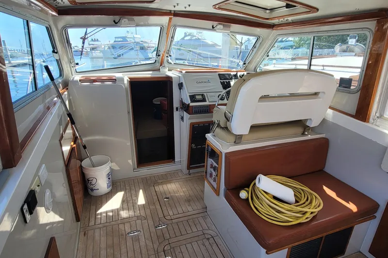 Slide: The Image of Interior of a 2015 Eastport 32 OBX boat with helm, seating, and nautical equipment. - 19