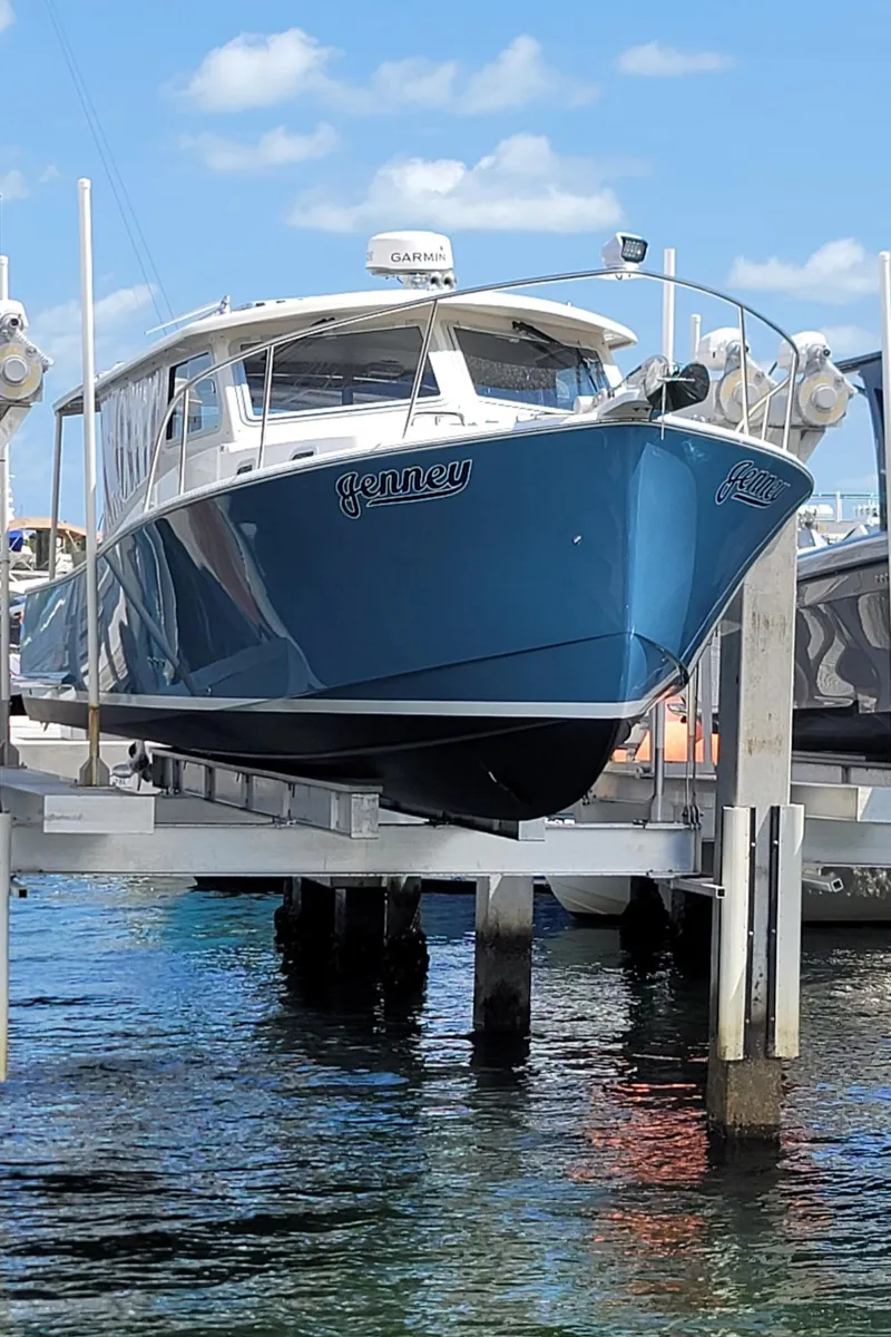 Slide: The Image of Blue Eastport 32 OBX boat from 2015 on a boat lift. - 2
