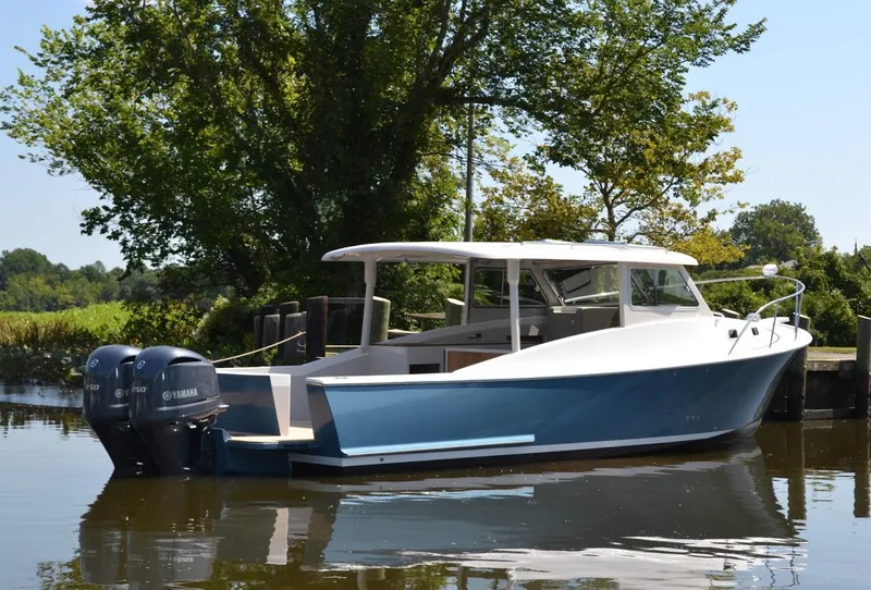 Slide: The Image of 2015 Eastport 32 OBX boat on calm water. - 3